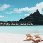 an island with cottages and beach chairs